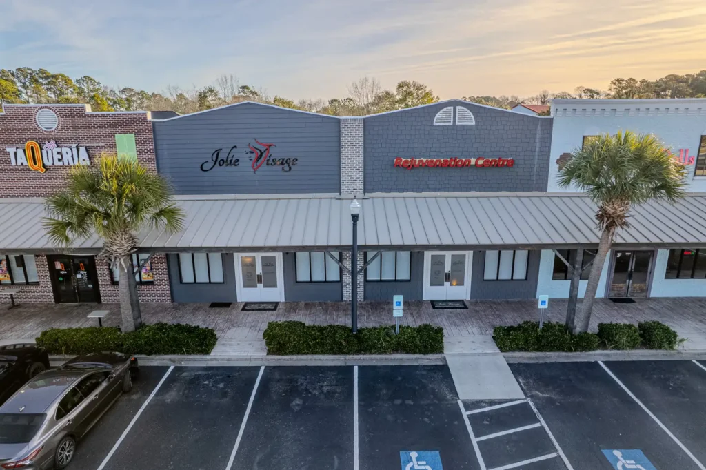 Terms and conditions page with Aerial drone view of the Jolie Visage Rejuvenation Centre medical spa building in Murrells Inlet, SC.
